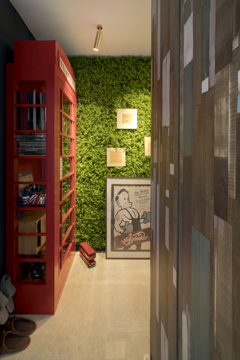 red cabinet with greenery wall